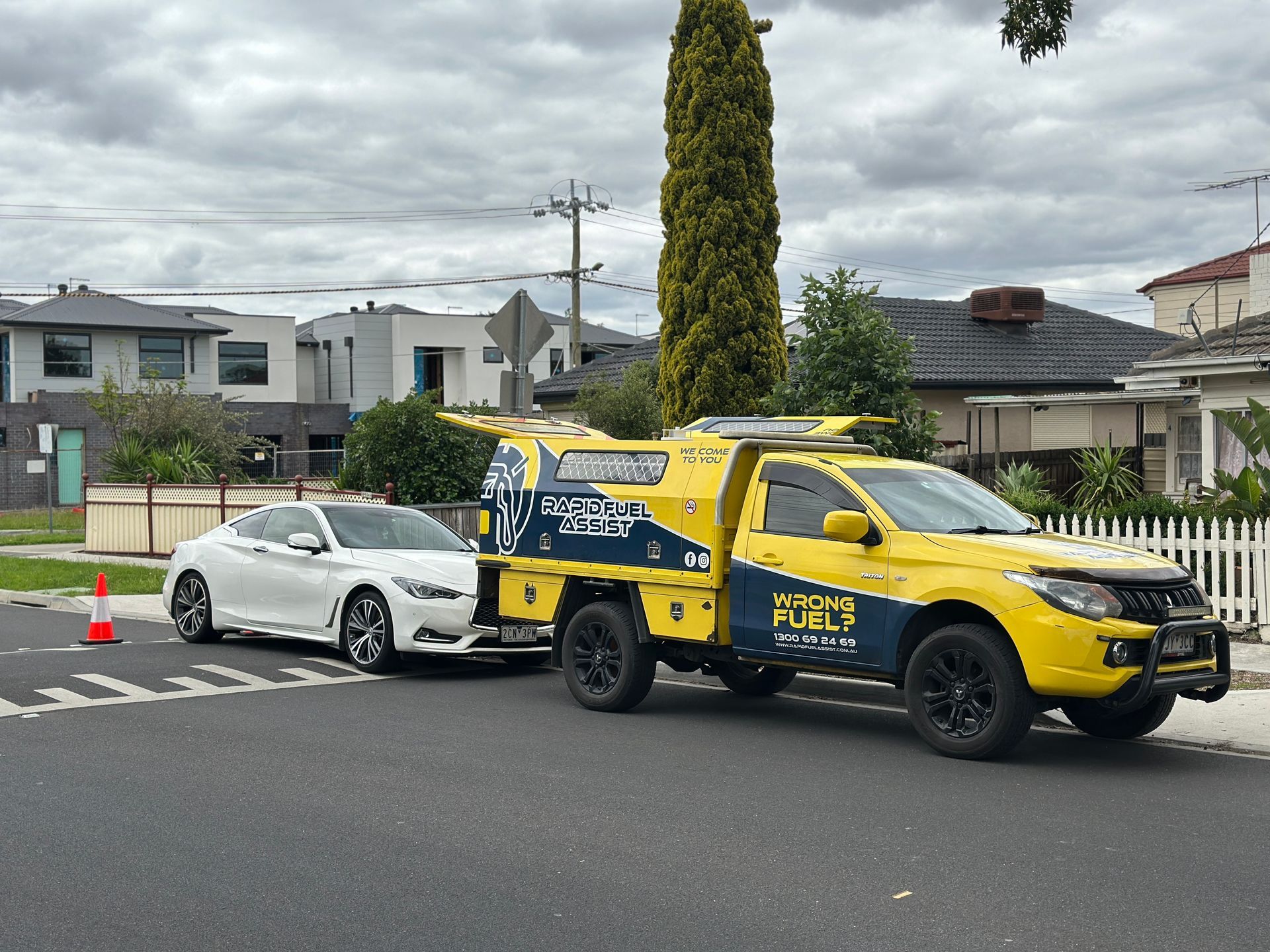 Rapid Fuel Assist service ute draining fuel from a white car on a street in Sunshine, Melbourne