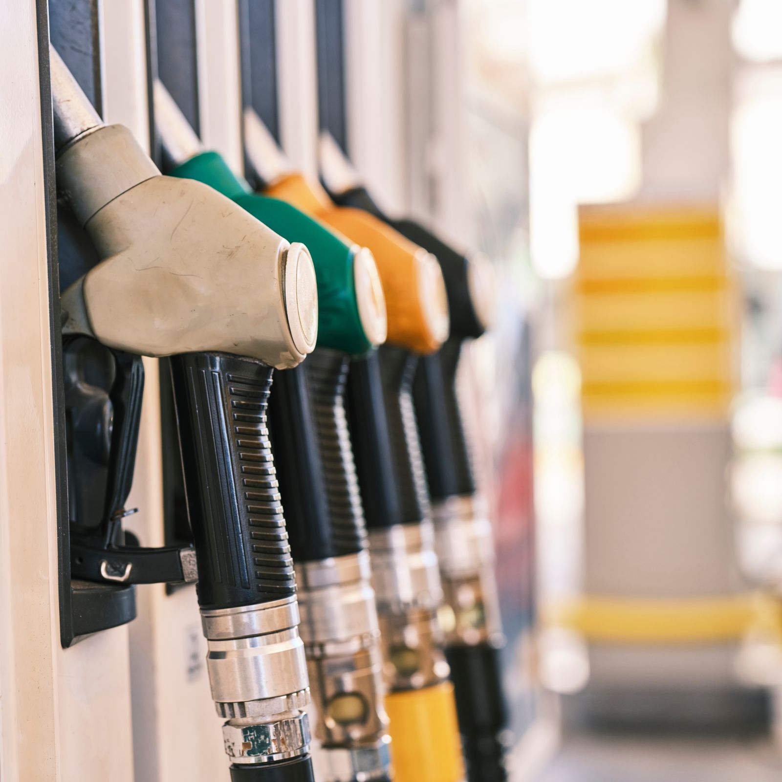 Row of fuel nozzles with different coloured handles