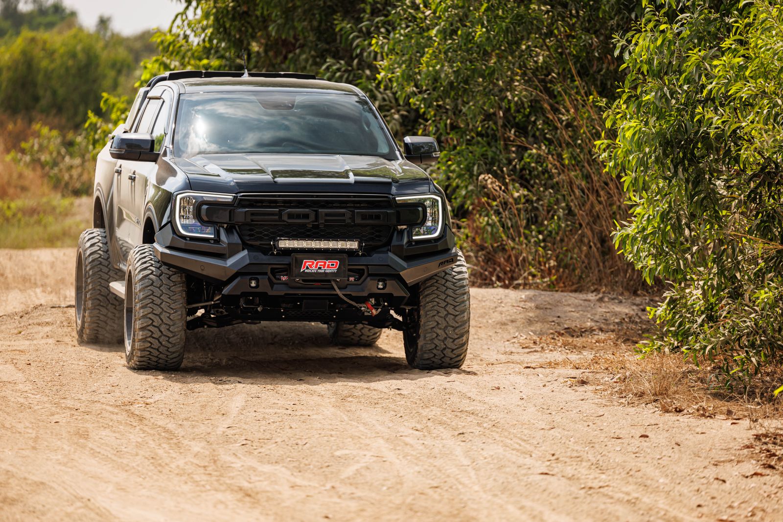 Black ute parked on a dirt track
