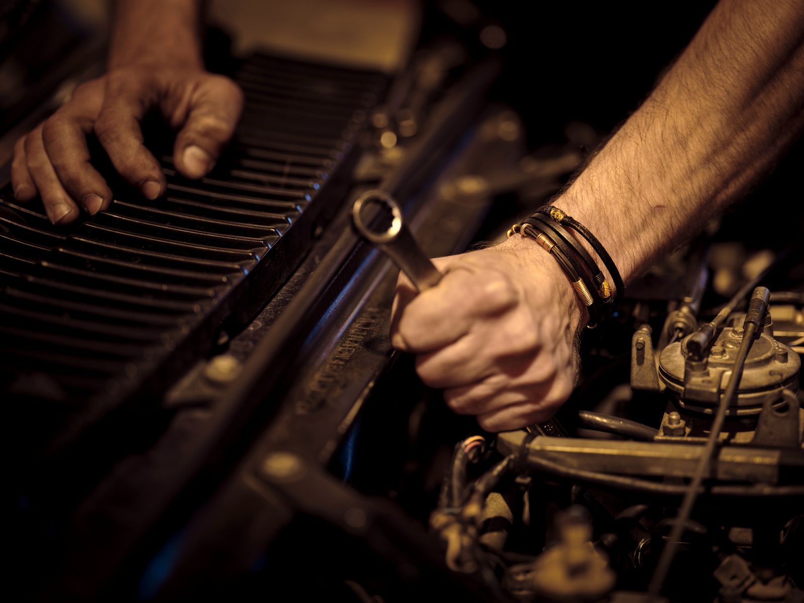 Mechanic tightening a part with a spanner
