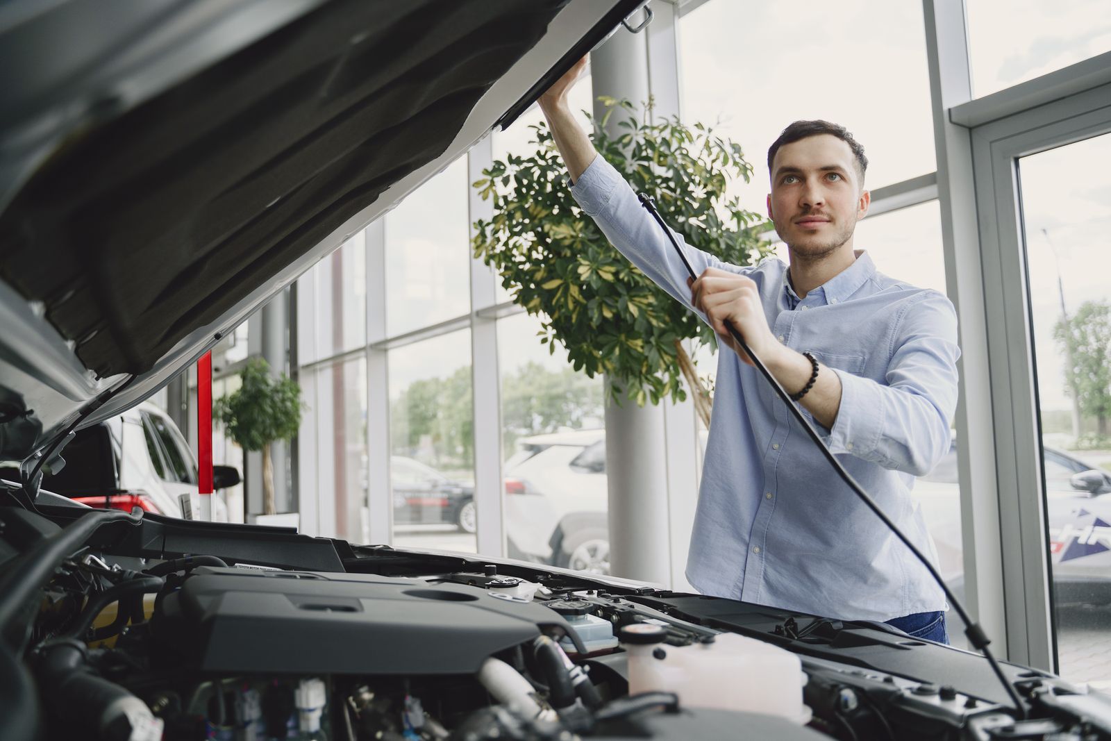 Man checking under the bonnet of his car