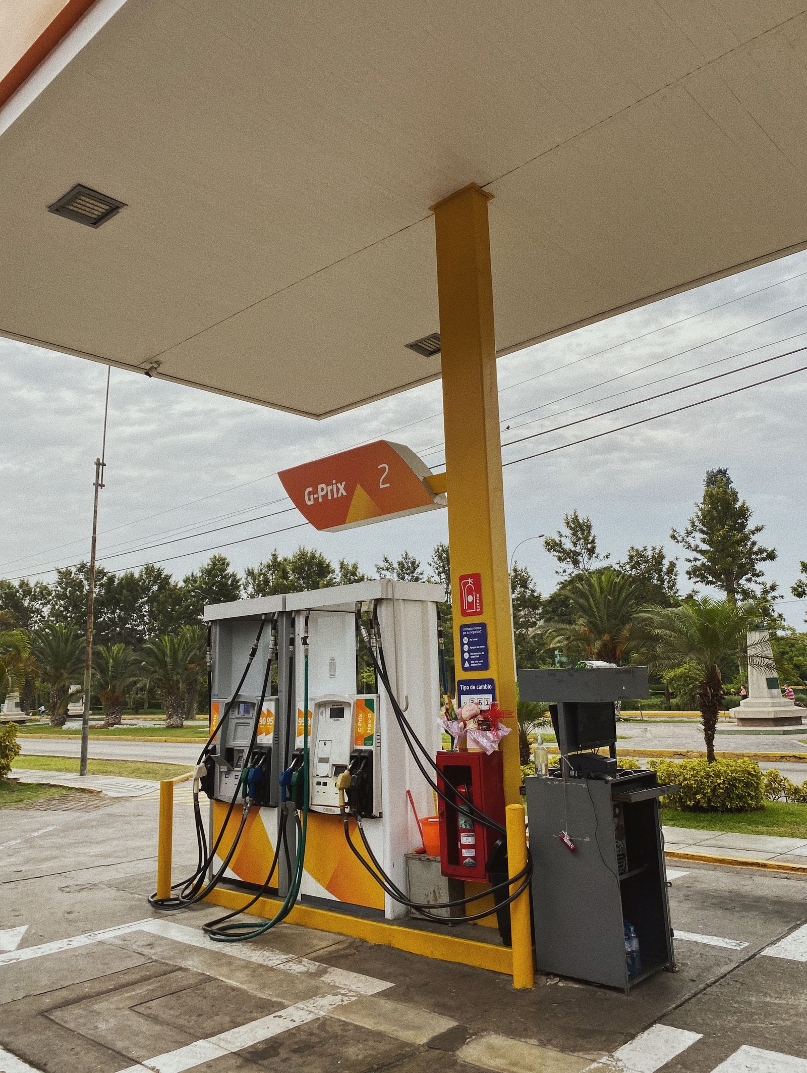 Fuel bowsers under a service station canopy